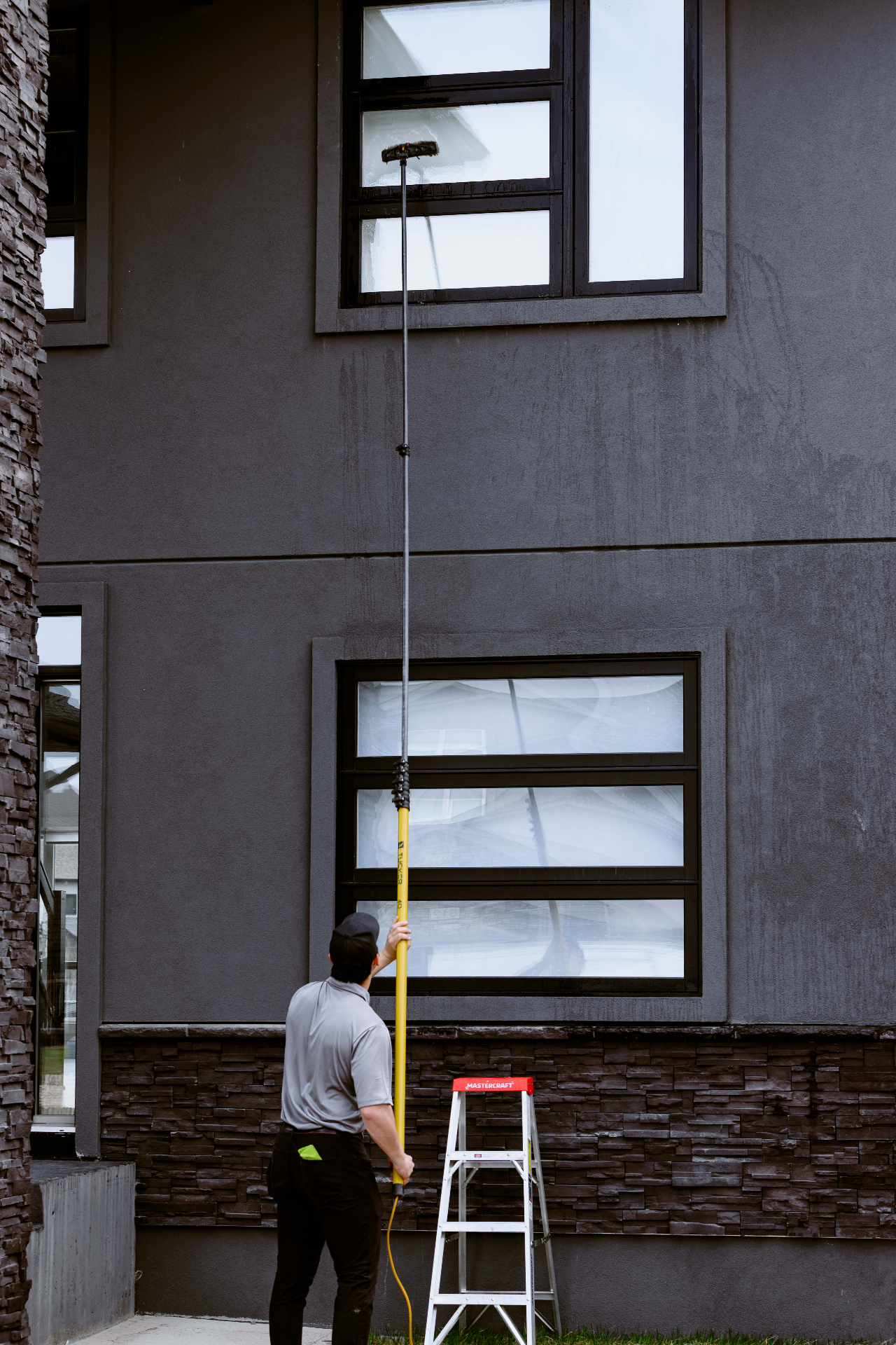 Clear Windows technician working outside a home