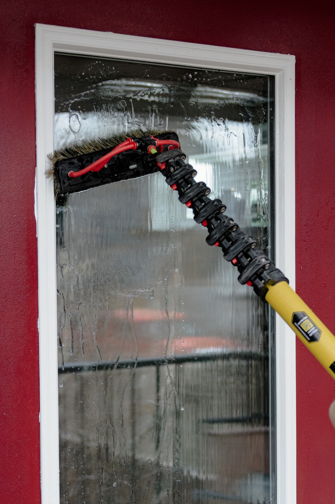 Close-up of exterior window cleaning brush in action