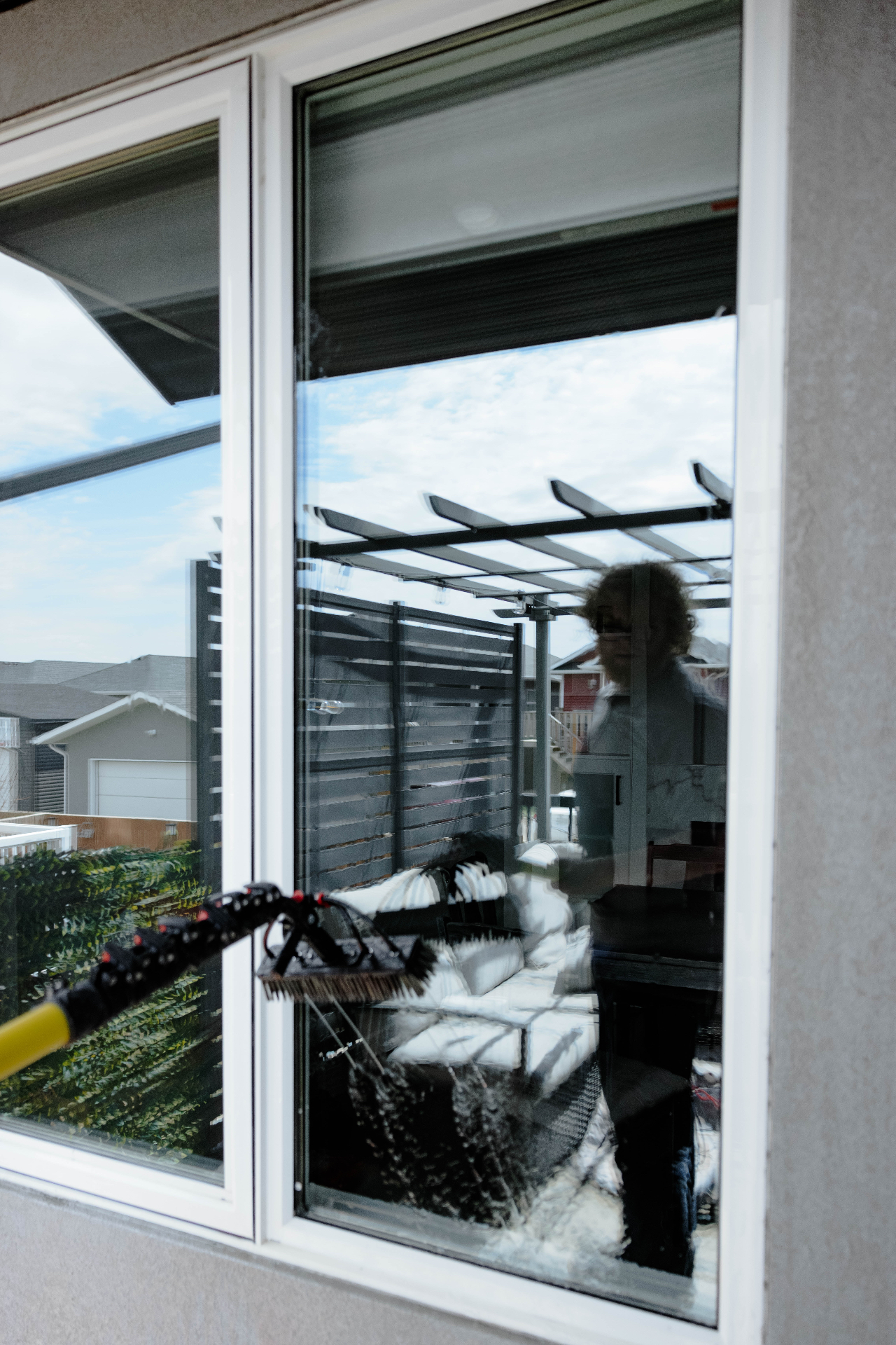 Window cleaning brush gliding across exterior glass